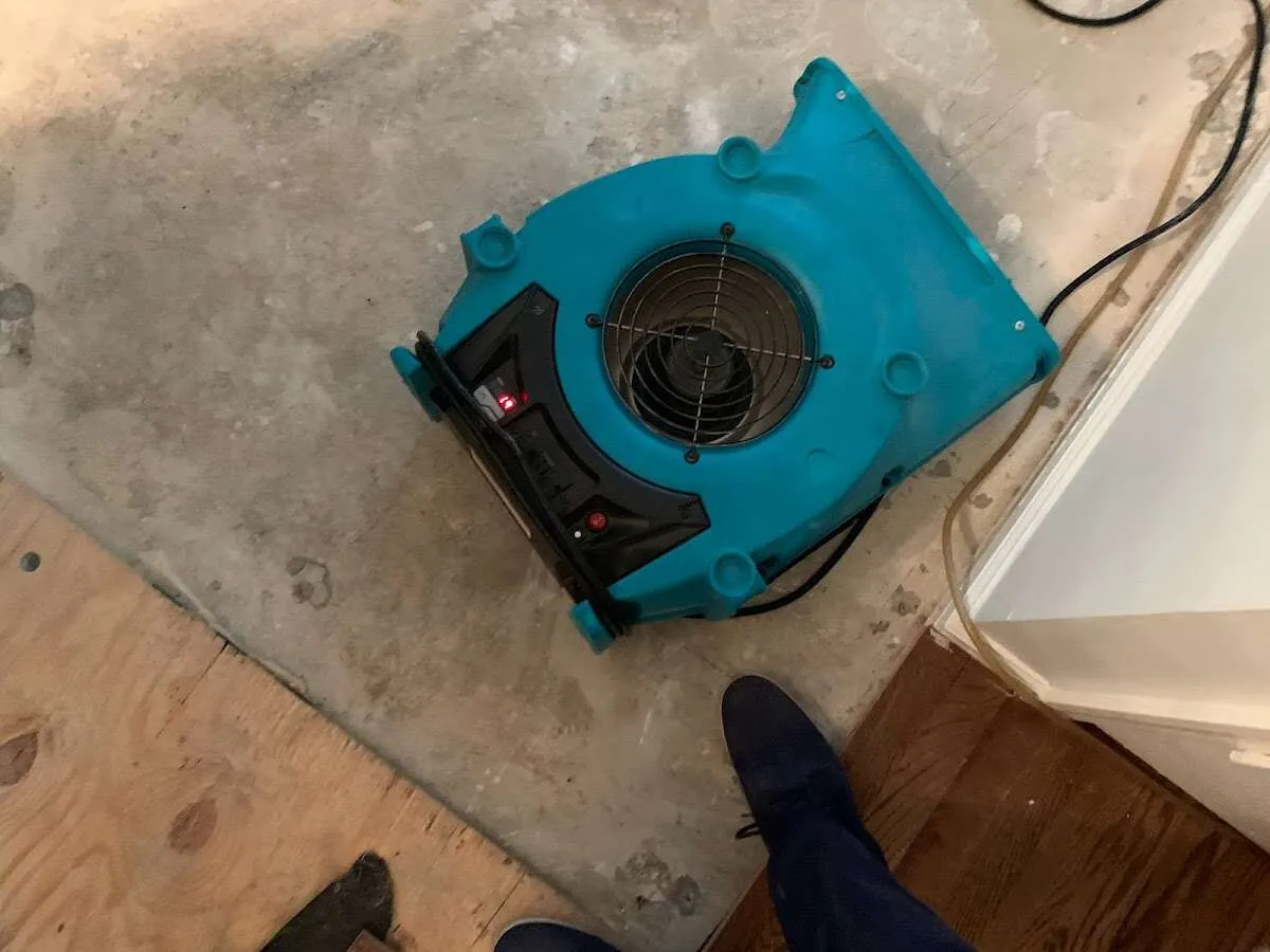 Air mover drying subfloor during Commercial Water Damage Restoration in Miamisburg
